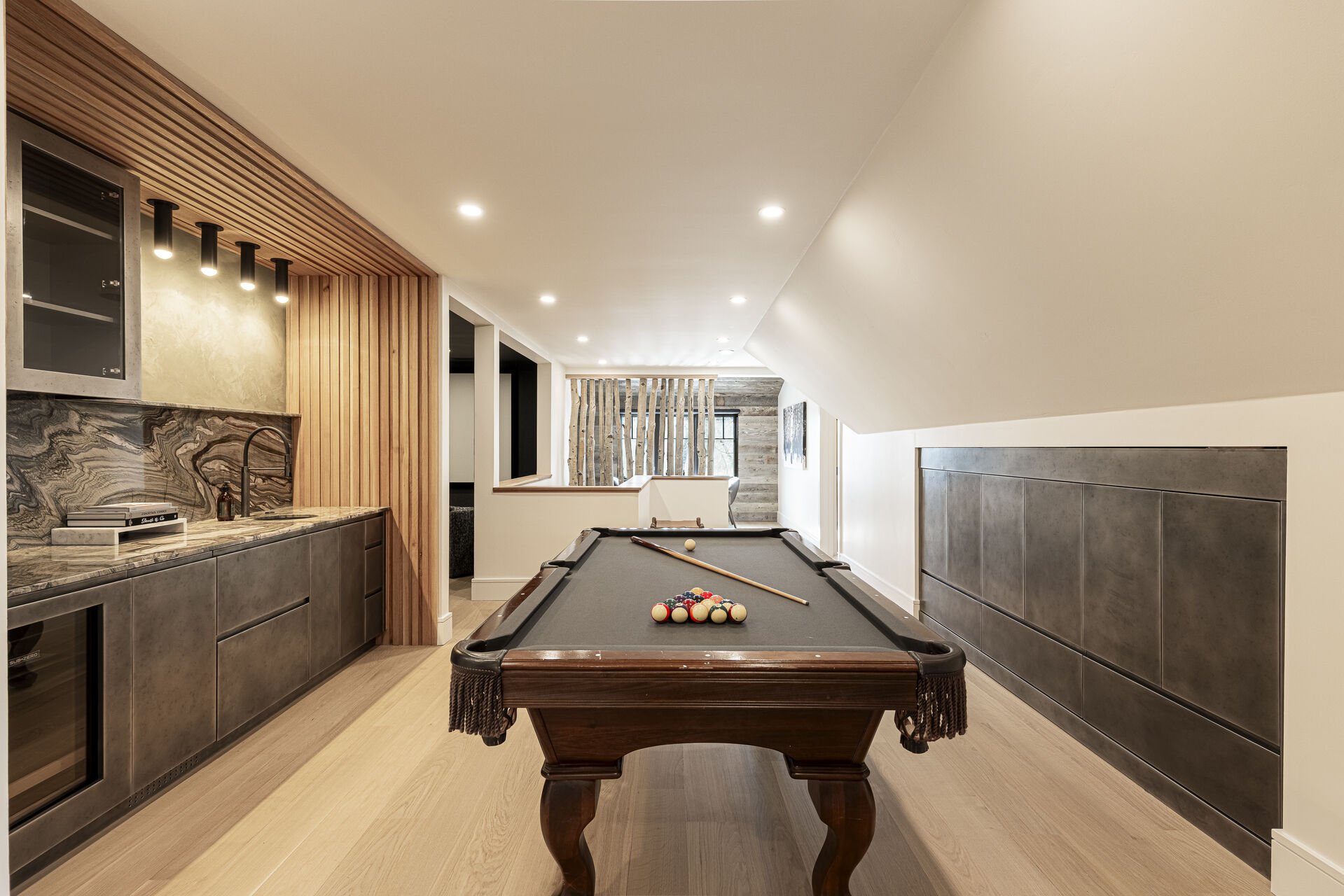 Sun Peak Manor House - Upper level game room with a wet bar with mini fridge and pool table Sun Peak Manor House - Upper level game room with a wet bar with mini fridge and pool table
